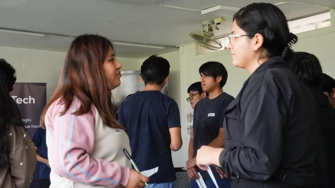 Estudiantes en duplas conversando con sus tarjetas en la mano