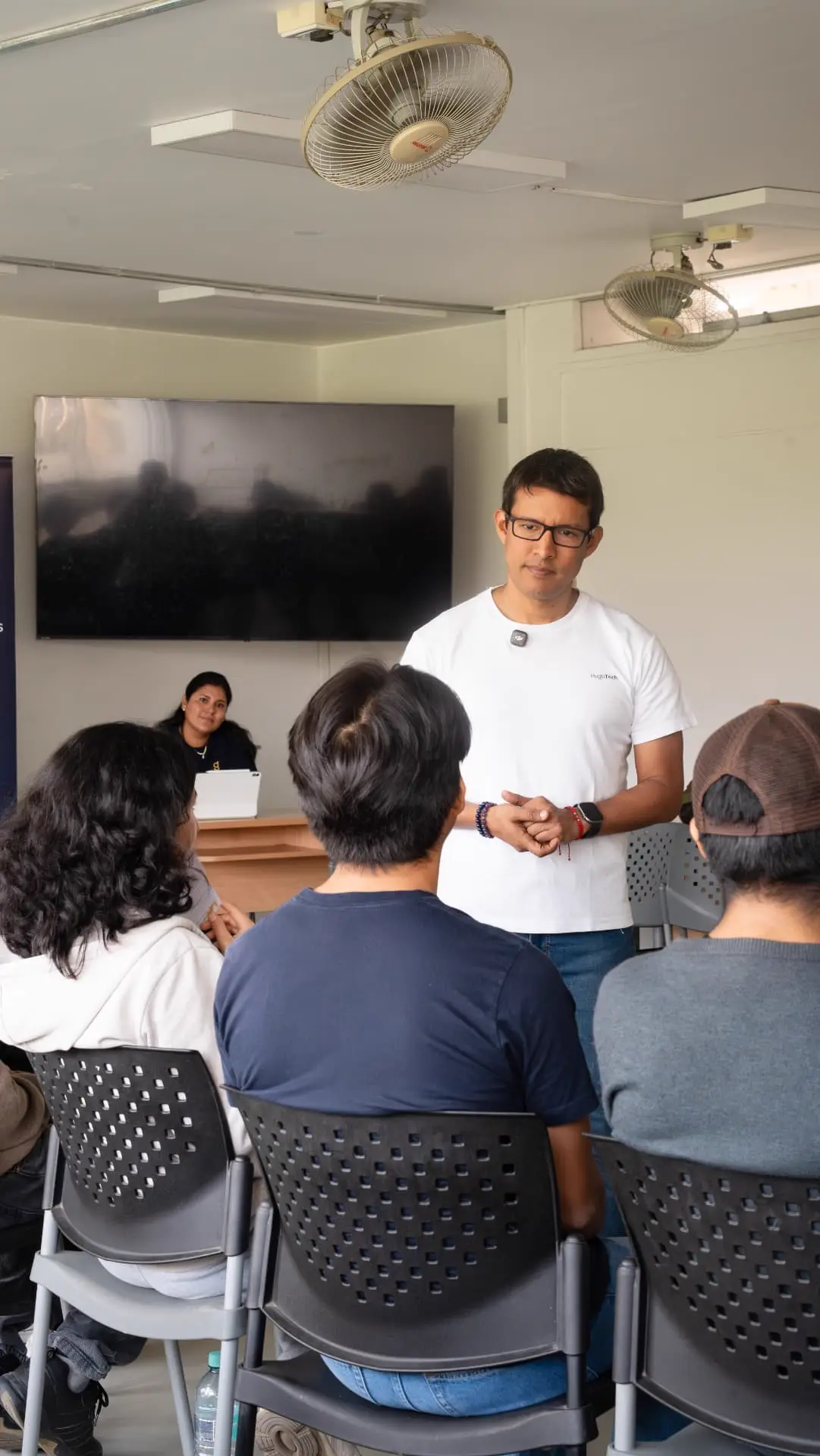 Hugo facilitando frente a un grupo sentado en aula universitaria